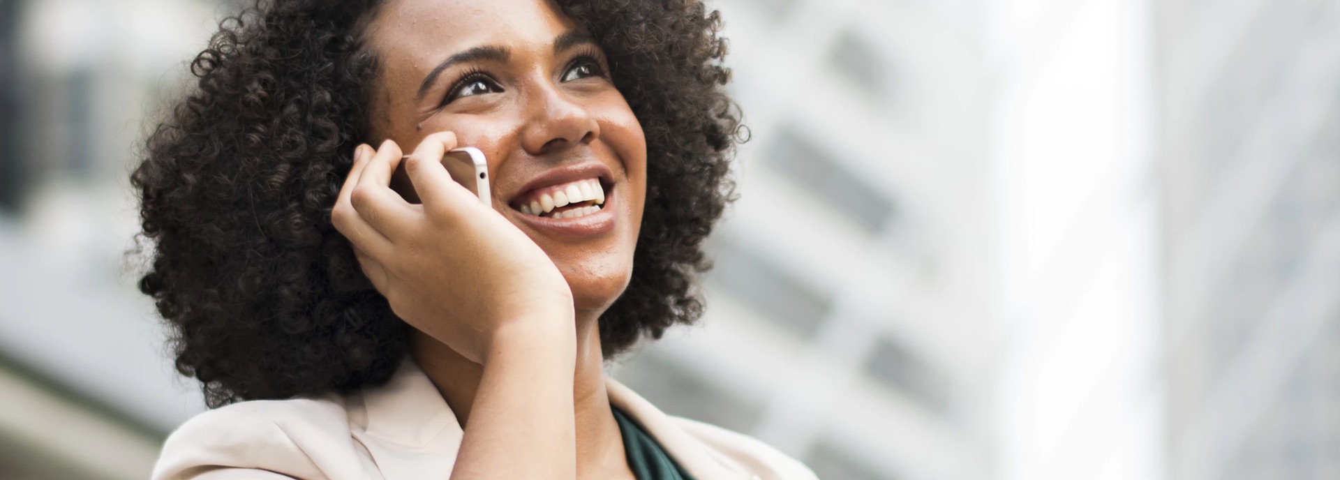 A woman talking on a cellphone and smiling