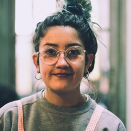 An employee's headshot photo wearing glasses